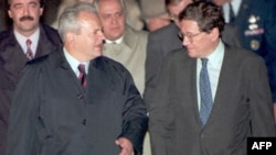 Serbian President Slobodan Milosevic (left) is greeted by U.S. Assistant Secretary of State Richard Holbrooke after arriving at Wright-Patterson Air Force Base near Dayton, Ohio, on October 31, 1995.