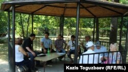 Алмат Жумагулов (третий слева)в парке имени Махатмы Ганди беседует с активистом Рамазаном Есергеповым перед началом марша, организованного тогда Есергеповым. Алматы, 29 июля 2017 года.