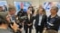 Israeli President Isaac Herzog (second right) speaks to RFE/RL's Ray Furlong (second left) on March 12 