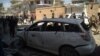 Kabul residents walk past the ruins and rubble aftre a blast at voter-registration center on April 22.