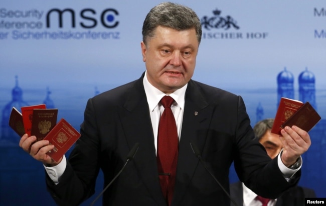 Президент України Петро Порошенко демонструє на Мюнхенській конференції з безпеки військові квитки та паспорти військовослужбовців Росії, які були здобуті в зоні бойових дій на Донбасі. Мюнхен, 7 лютого 2015 року