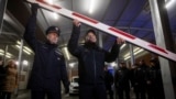 Romanian Chief Border Inspector Stoica Laurian Cornel and Janos Balogh, the director-general of the Hungarian Police, lift a barrier as Romania and Bulgaria both join the visa-free Schengen zone on January 1.