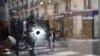 A bullet hole is shown on the window of a cafe located at the crossroads between the streets Saint-Augustin and Monsigny on May 13 in Paris, the day after a knifeman killed one man and wounded four other people. (AFP/Eric Feferberg)