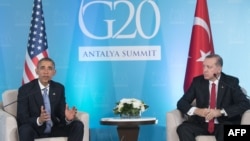 U.S. President Barack Obama (left) speaks as Turkish President Recep Tayyip Erdogan looks on during a meeting on the sidelines of the G20 summit in Antalya on November 15.