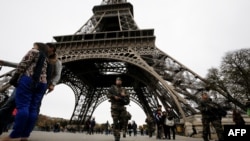 France -- French soldiers patrol the area at the foot of the Eiffel Tower in Paris on November 14, 2015 following a series of coordinated attacks in and around Paris late Friday which left more than 120 people dead. French President Francois Hollande b