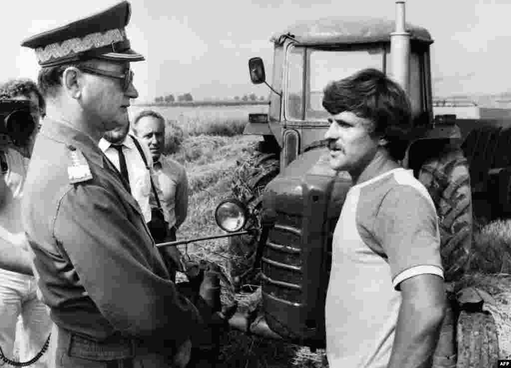 An undated photograph shows Jaruzelski (left) talking with farmer Krzyszto Zoltaski in a photo op from the village of Krolewo.