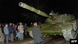 A Lithuanian demonstrator stands in front of a Soviet tank in January 1991.