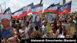 People attend a ceremony marking the fifth anniversary of the MH17 plane crash at a memorial near the village of Hrabove in Ukraine's Donetsk region on July 17, 2019.