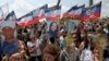 People attend a ceremony marking the fifth anniversary of the MH17 plane crash at a memorial near the village of Hrabove in Ukraine's Donetsk region on July 17, 2019.