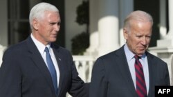 U.S. Vice President Joe Biden (right) walks with Vice President-elect Mike Pence following lunch at the Naval Observatory in Washington, D.C., in November 16.