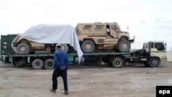 Trucks transporting NATO military vehicles destined for the Pakistani port city of Karachi cross into Pakistan near the Afghan border in Chaman on November 25.