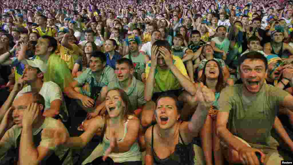 Fans of Ukraine react during a public screening of a Euro 2012 soccer match between Ukraine and England in the fan zone in Kyiv. (Reuters/Gleb Garanich)