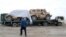 Trucks transporting NATO military vehicles destined for the Pakistani port city of Karachi cross into Pakistan near the Afghan border in Chaman on November 25.