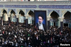 Mourners attend prayers for Iran's late Supreme Leader Ayatollah Ali Khamene at the Jamkaran Mosque in Qom on July 7.