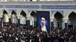 A large, likely AI-generated image of Iran's Supreme Leader Mojtaba Khamenei is shown during a ceremony to honor his father, slain Supreme Leader Ayatollah Ali Khamenei, in Qom on July 7.