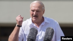 BELARUS -- Belarusian President Alyaksandr Lukashenka gestures as he delivers a speech during a rally of his supporters near the Government House in Independence Square in Minsk, Belarus August 16, 2020.