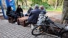 Ukraine - people sit outside in Kherson - Reuters screen grab