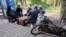 Ukraine - people sit outside in Kherson - Reuters screen grab