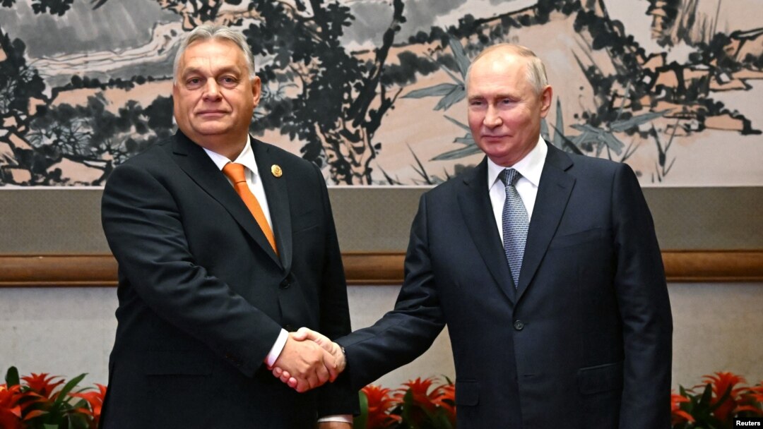 Russian President Vladimir Putin (right) and Hungarian Prime Minister Viktor Orban shake hands at a meeting in Beijing earlier this month. 