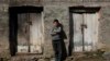 Nine-year-old Bacho Tsiklauri leans against his home in Makarta, some 100 kilometers north of the Georgian capital, Tbilisi.