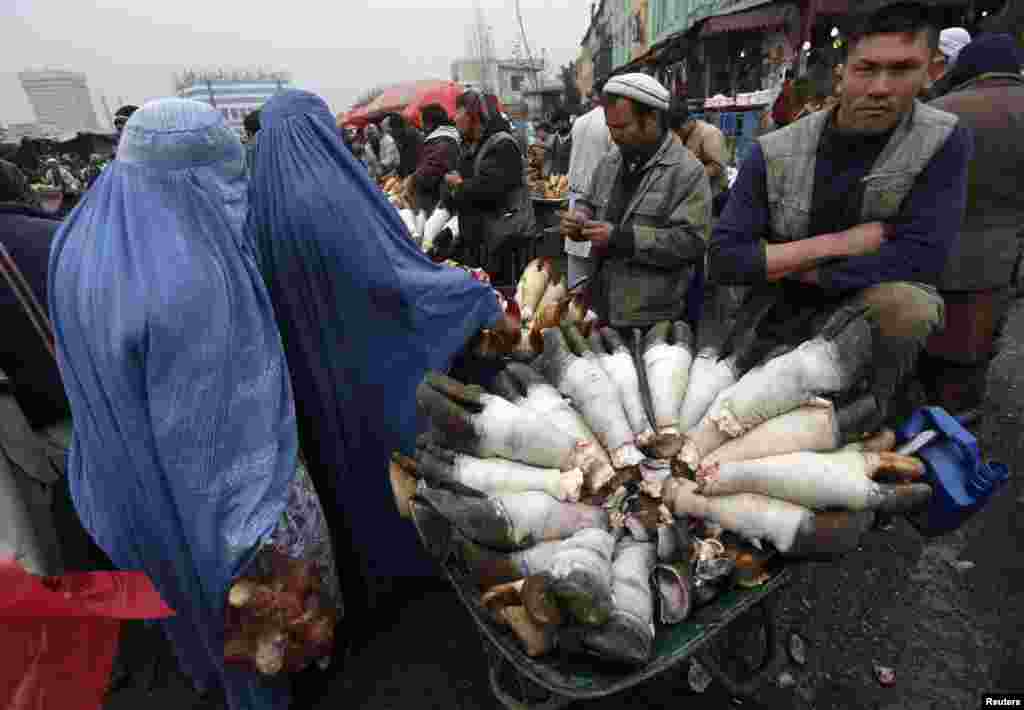 An Afghan butcher sells buffalo legs along a street in Kabul. (Reuters/Omar Sobhani) 