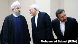 Iranian President Hassan Rouhani (L), talking with his foreign minister Mohammad Javad Zarif (C) and accompanied with his chief of staff Mahmoud Vaezi, just before a meeting with Venezuela's President Nicolas Maduro, on September 10, 2017. File photo