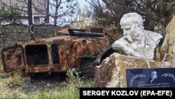 UKRAINE – A damaged monument of Ukrainian poet Taras Shevchenko near a destroyed armoured personnel carrier (APC) at Cherkaski Tyshky village in Kharkiv's area, amid Russia's invasion, 23 October 2022