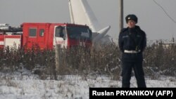 Polisiýa uçaryň ýykylan sebitine gözegçilik edýär. 27-nji dekabr, 2019 ý.