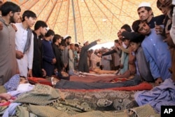 Relatives surround the dead bodies of Afghan civilians who were allegedly killed during a military operation against militants in the Rodat district of Nangarhar Province on October 24.