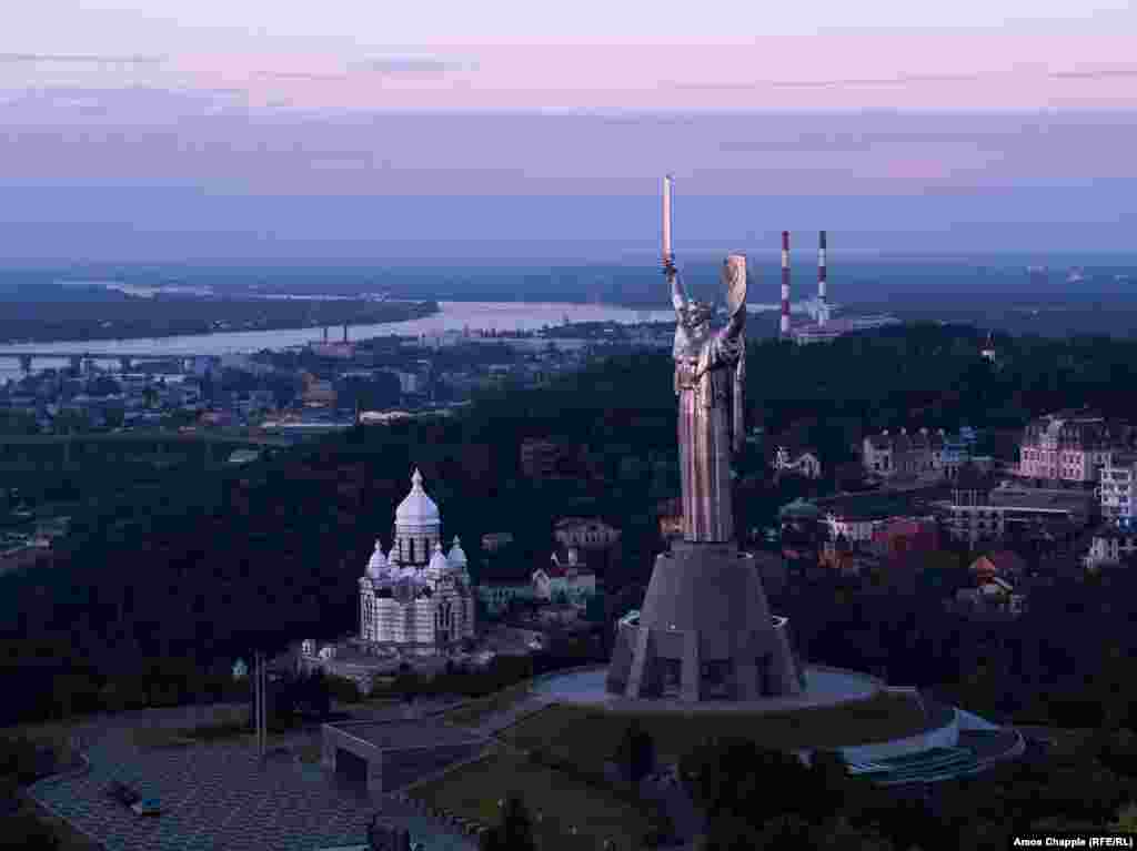 An aerial view of the Motherland monument in Kyiv at sunrise on July 9. (RFE/RL/Amos Chapple)