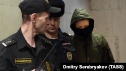 Former Moscow police officer Roman Feofanov (right) arrives for a hearing at Moscow's Basmanny court on January 29.