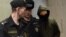 Former Moscow police officer Roman Feofanov (right) arrives for a hearing at Moscow's Basmanny court on January 29.