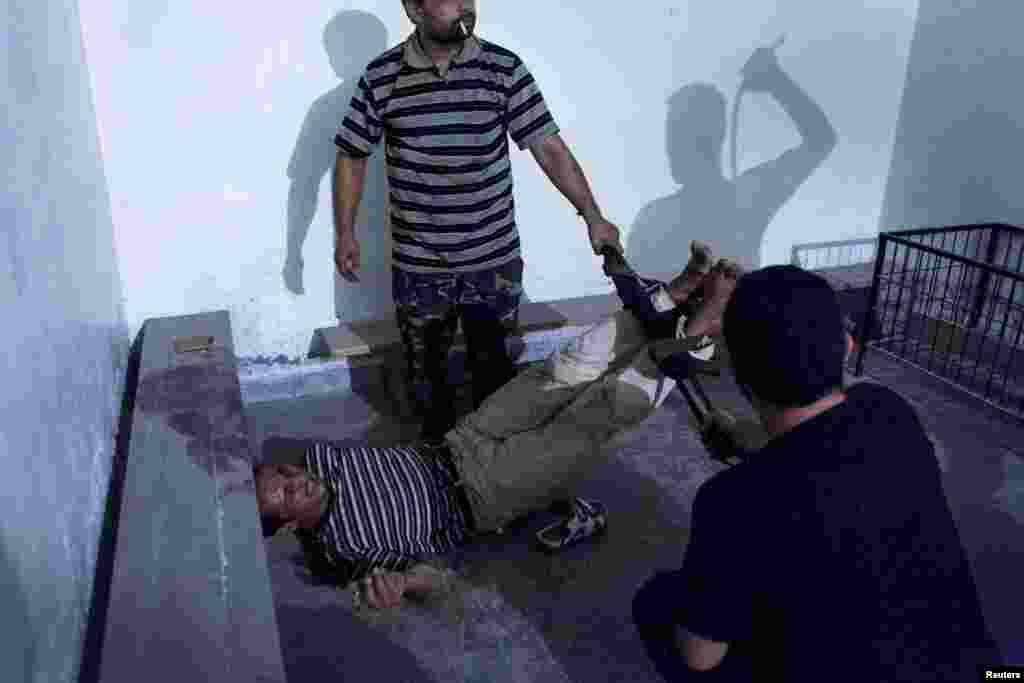 Emin Ozmen of Turkey won second prize in the Spot News Single category with this picture of Syrian opposition fighters interrogating and torturing an informant in Aleppo.