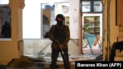 A soldier stands guard at the mosque hit by the bomb blast.