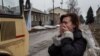 A woman cries as she watches her relatives prepare to be evacuated from Debaltseve.