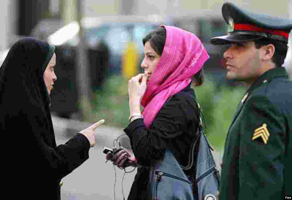 Police and Basij activists check women for proper dress in Tehran on April 22 (Fars) - April 27, 2007 (RFE/RL) -- Iranian police have launched a fresh crackdown on women caught violating strict Islamic dress-code rules. Such crackdowns on women wearing loose head scarves, tight or short coats, short pants, or make-up have become a routine part of Iranian life as summer approaches.