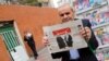 An Iranian man holds a copy of the daily Sharq newspaper with pictures of Iranian President Hassan Rohani and headline reading 'Decisive victory for the reformist' outside a kiosk in Tehran. Undated