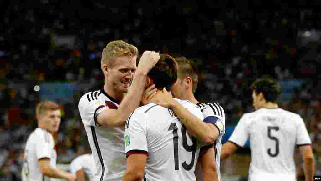 BRAZIL SOCCER FIFA WORLD CUP 2014 -- Mario Goetze (C) of Germany celebrates with teammates after scoring the opening goal during the FIFA World Cup 2014 final between Germany and Argentina at the Estadio do Maracana in Rio de Janeiro, Brazil, 13 July 2014