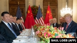 U.S. President Donald Trump (right) and China's President Xi Jinping (left), along with members of their delegations, hold a dinner meeting at the end of the G20 summit in Buenos Aires on December 01.