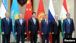 Participants of a Shanghai Cooperation Organization (SCO) summit pose for a photo in Bishkek, September 13, 2013