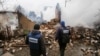 OSCE observers inspect a building that was destroyed after reported shelling in Avdiyivka in eastern Ukraine in February.