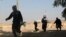 Masked Sunni gunmen take up position during fighting in Fallujah, iraq. (file photo)