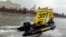 Greenpeace activists hold flags reading "Free the Arctic 30" as they go past the Kremlin by boat earlier this month.