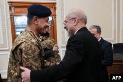 Iranian Parliament speaker Mohammad Baqer Qalibaf greets Pakistan's army chief Asim Munir before their meeting in Tehran on April 16.