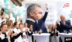 Austrian Chancellor and head of the Austrian People’s Party Karl Nehammer (center) greets supporters during an election rally outside the party headquarters in Vienna on September 27.