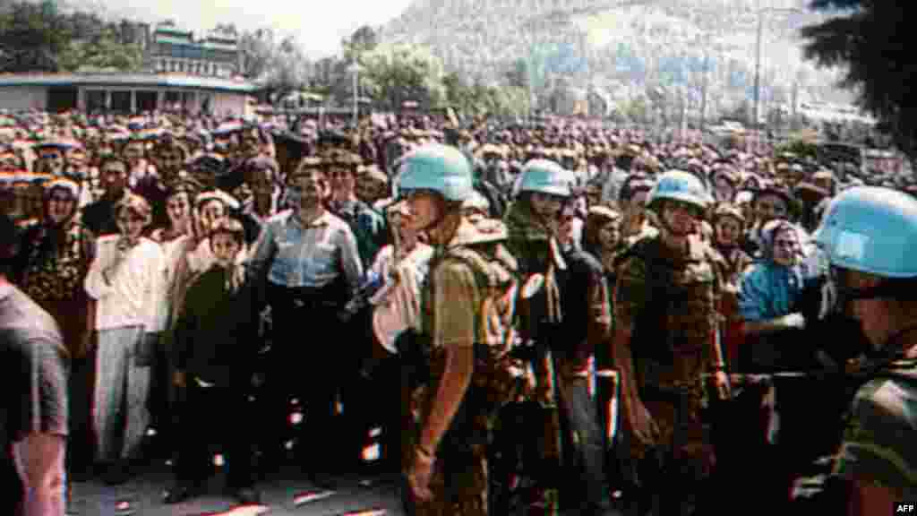 Dutch UN soldiers stand in front of Bosnian Muslim refugees in Potocari, site of the Dutch UN base in the Srebrenica enclave, before the massacre in July 1995.