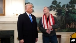 U.S. President Donald Trump welcomes American Marc Fogel to the White House.