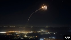 Rockets fired from southern Lebanon are intercepted by Israel's Iron Dome air-defense system over the Upper Galilee region in northern Israel on August 4.