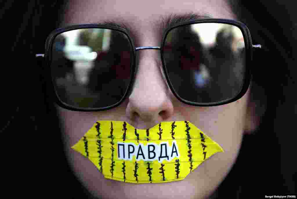 A student wearing tape on her mouth takes part in a protest against presidential election results in Minsk. (TASS/Sergei Bobylev)
