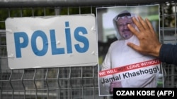 A protester holds a picture of missing journalist Jamal Khashoggi during a demonstration in front of the Saudi Arabian Consulate in Istanbul on October 5.